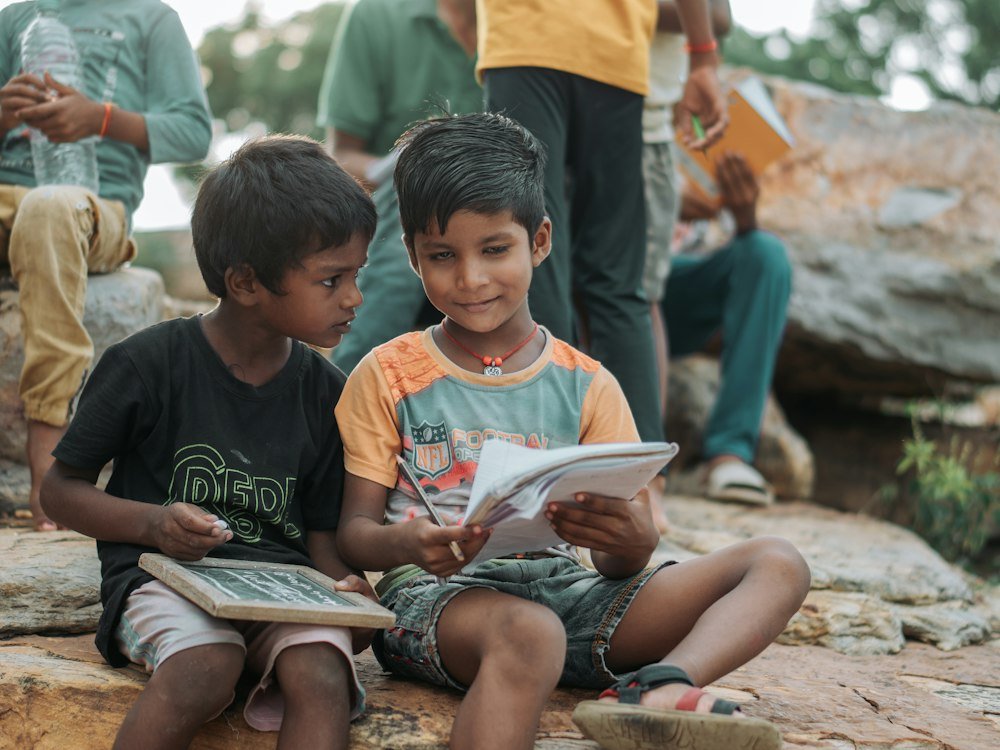 Children learning together with slate and notebook in an open community education initiative - Sahayata Association Foundation